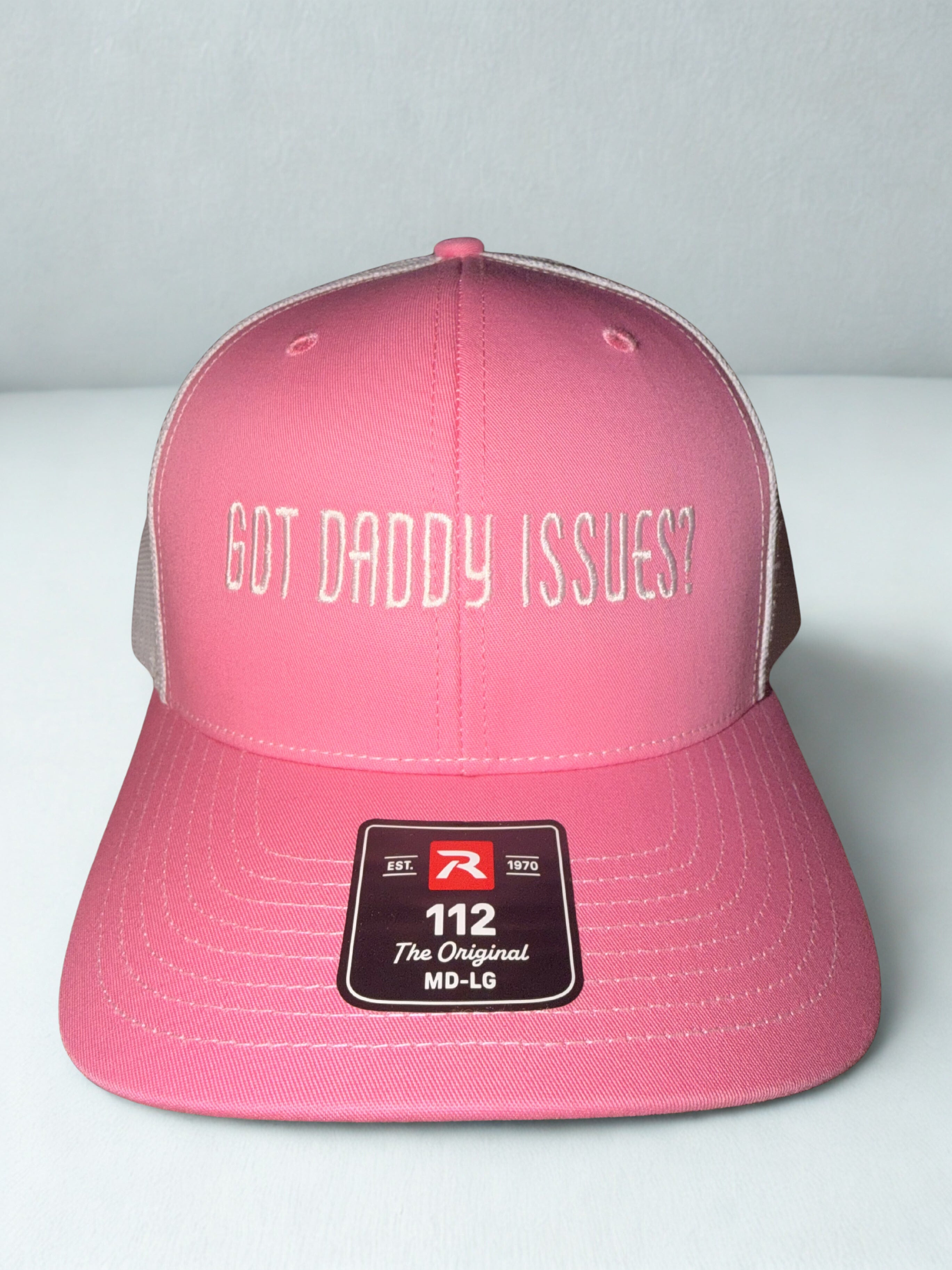 Pink and white trucker hat with ‘Got Daddy Issues?’ embroidered on front and Shaylen signature embroidered on back