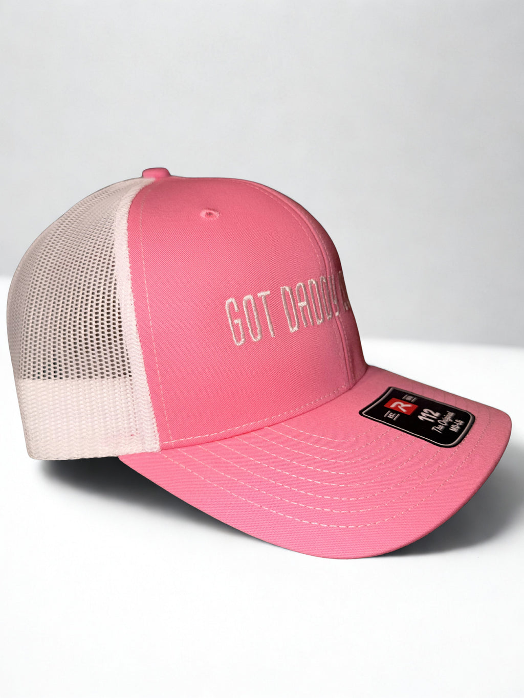 Pink and white trucker hat with ‘Got Daddy Issues?’ embroidered on front and Shaylen signature embroidered on back