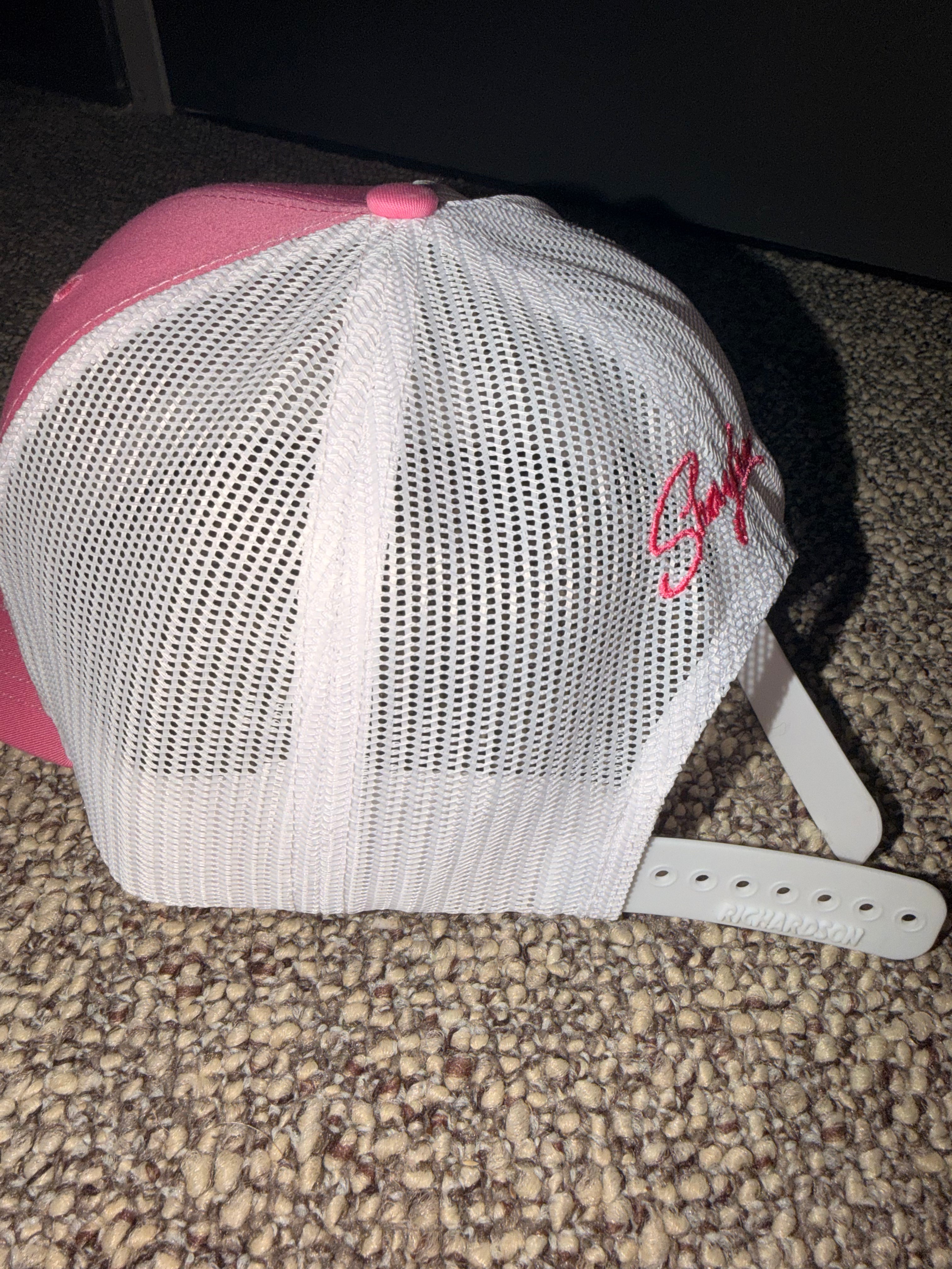 Pink and white trucker hat with ‘Got Daddy Issues?’ embroidered on front and Shaylen signature embroidered on back