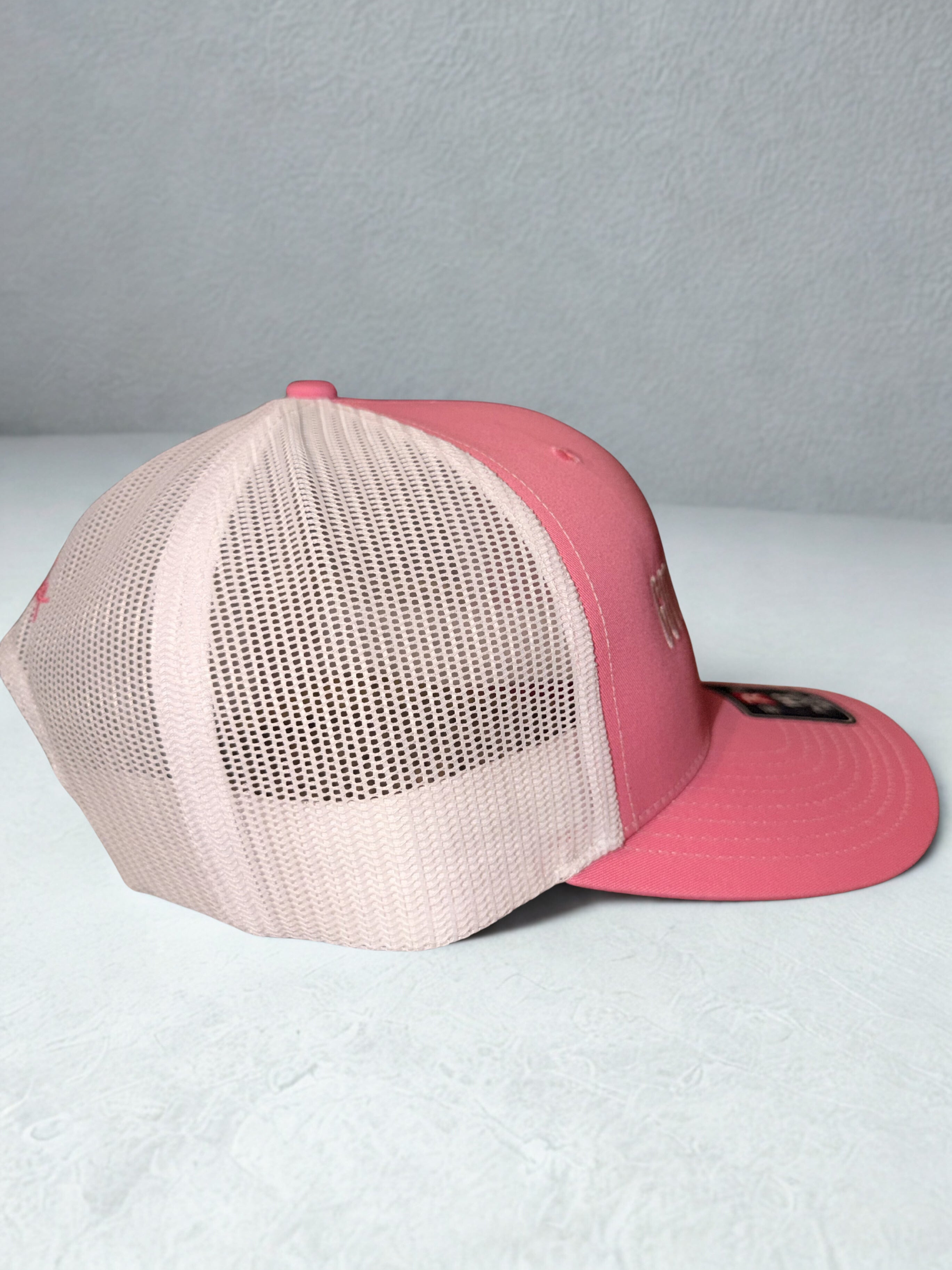 Pink and white trucker hat with ‘Got Daddy Issues?’ embroidered on front and Shaylen signature embroidered on back